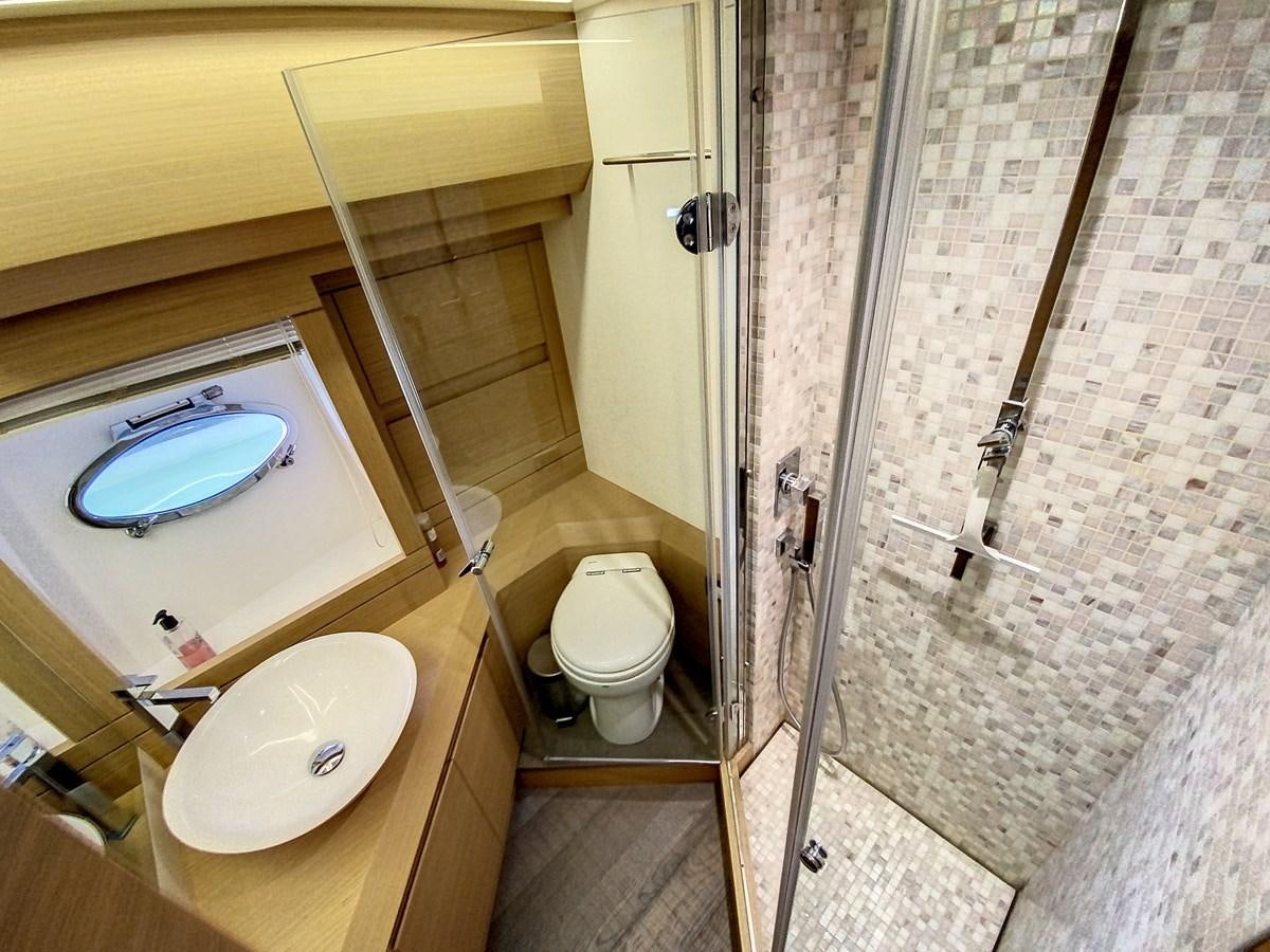 a bathroom with a tub and toilet aboard X-TREM I Yacht for Sale