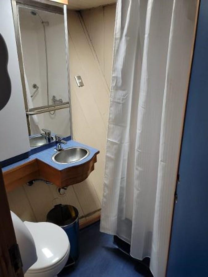 a bathroom with a sink and toilet aboard 2005 CUSTOM PILOT BOAT Yacht for Sale