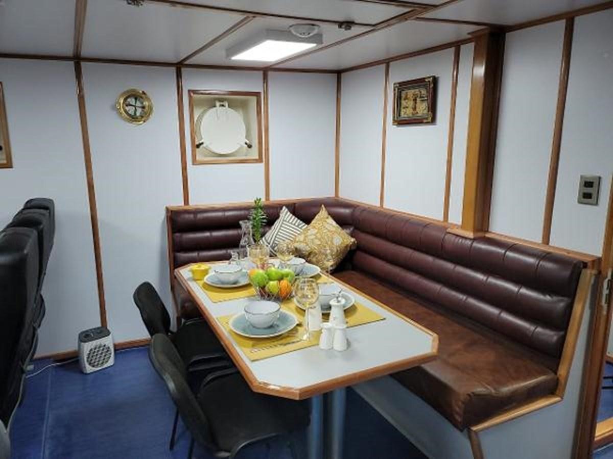 a dining table in a room aboard 2005 CUSTOM PILOT BOAT Yacht for Sale