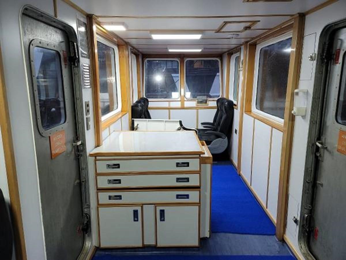 a room with a desk and a chair aboard 2005 CUSTOM PILOT BOAT Yacht for Sale