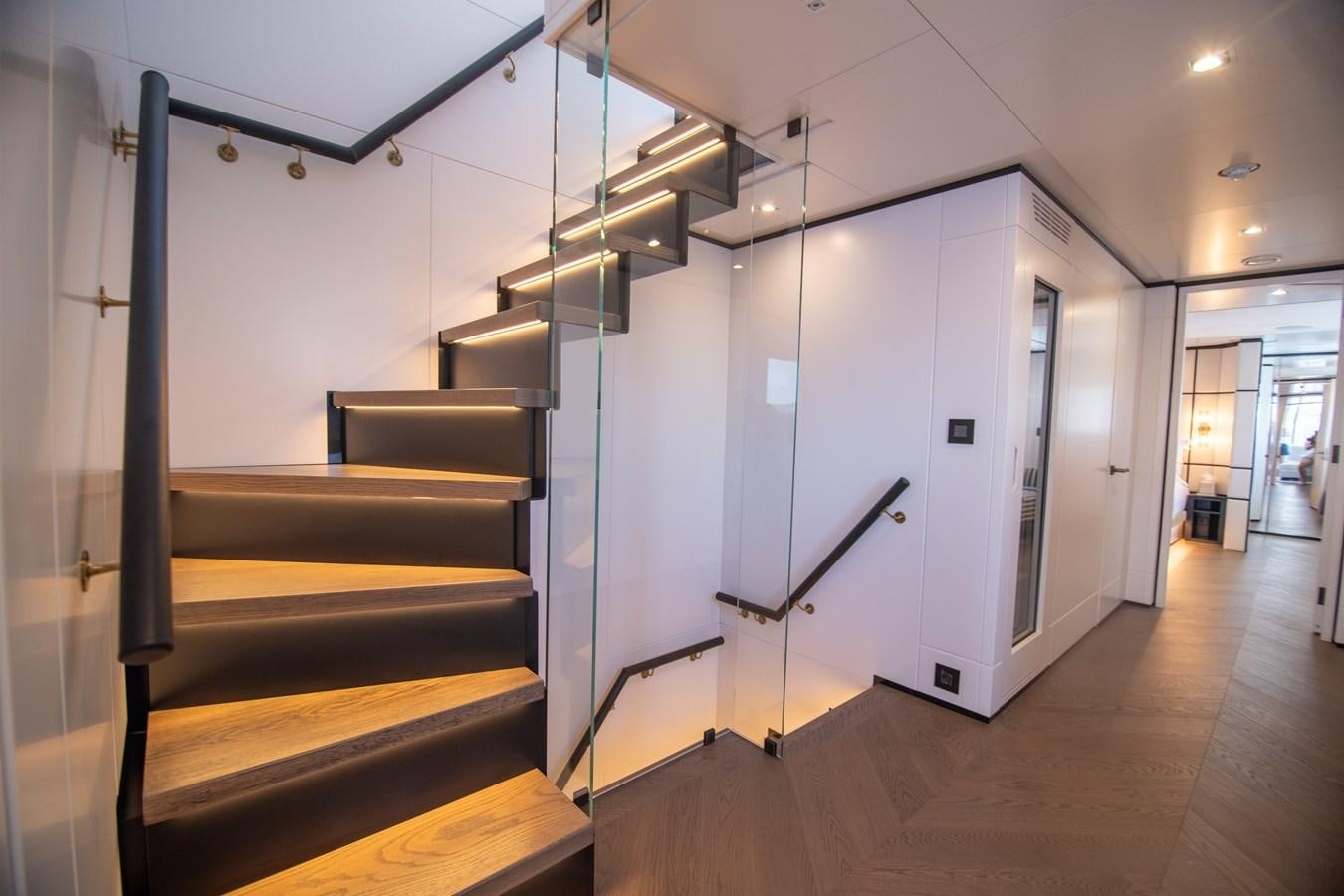 a room with a set of stairs aboard FOX Yacht for Sale