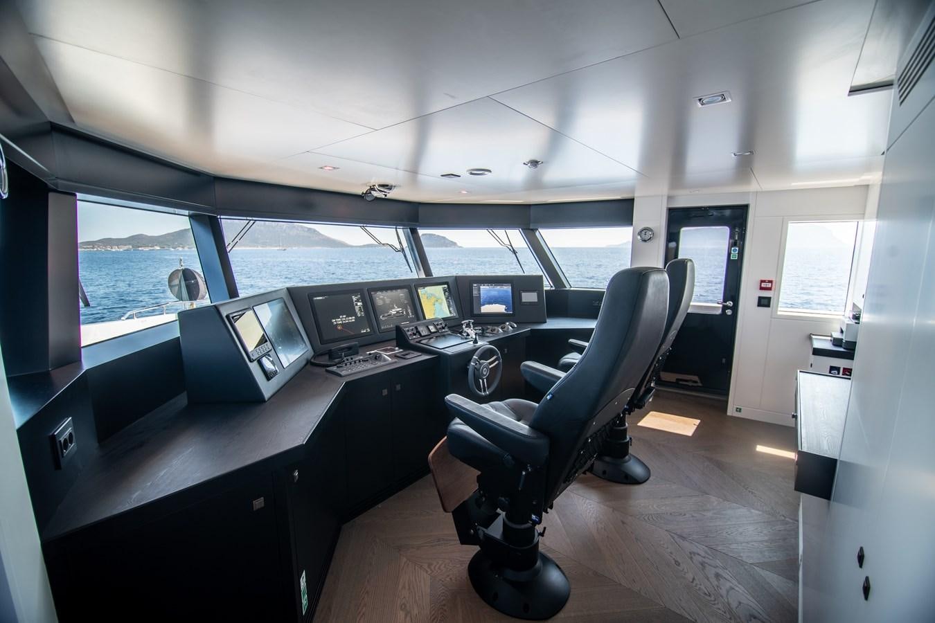 a room with a desk and chairs aboard FOX Yacht for Sale