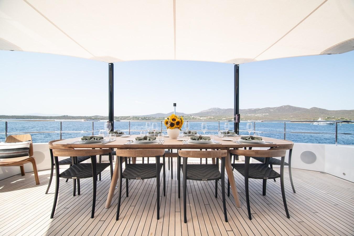 a table with chairs around it aboard FOX Yacht for Sale