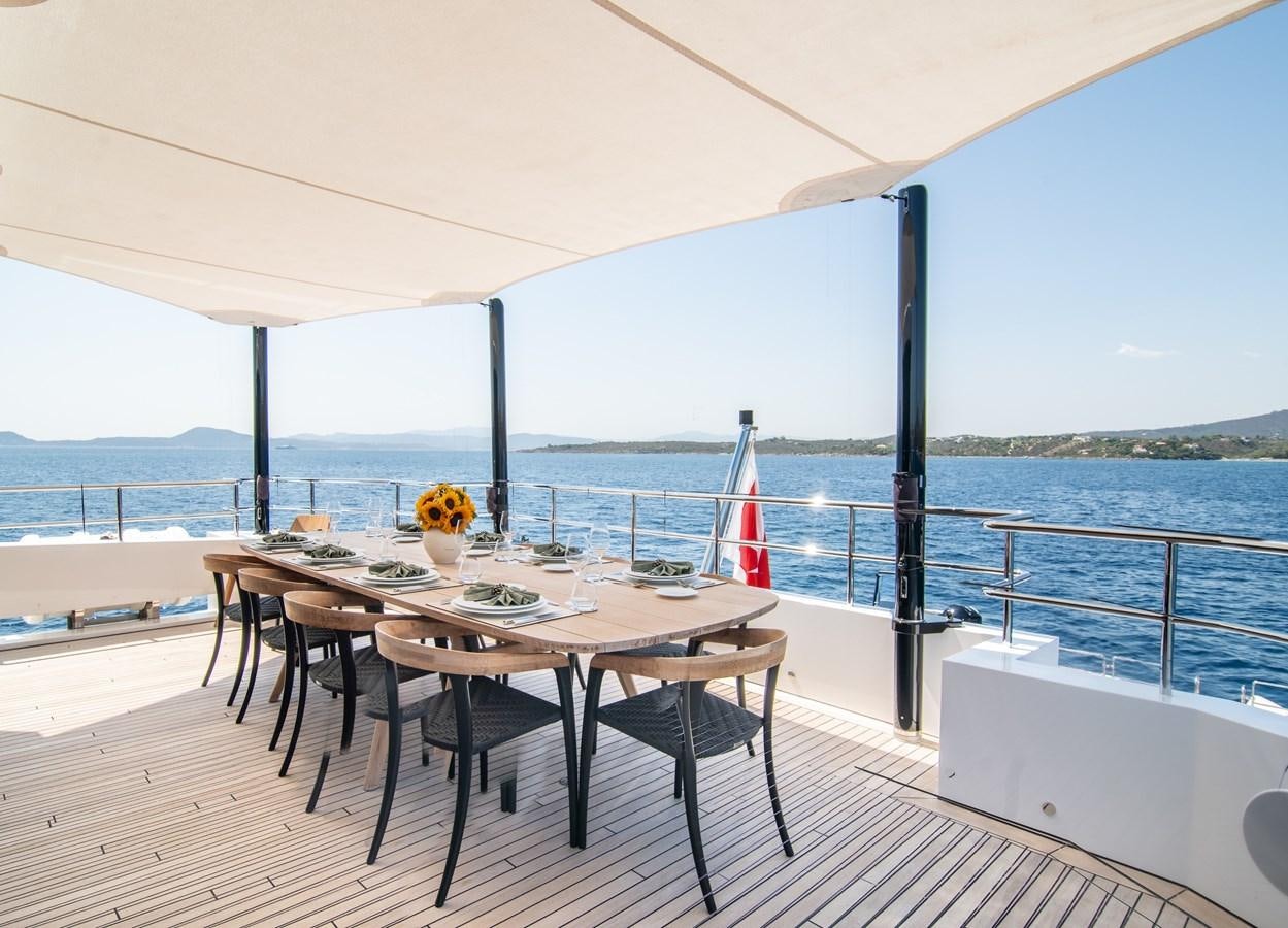 a table on a deck aboard FOX Yacht for Sale