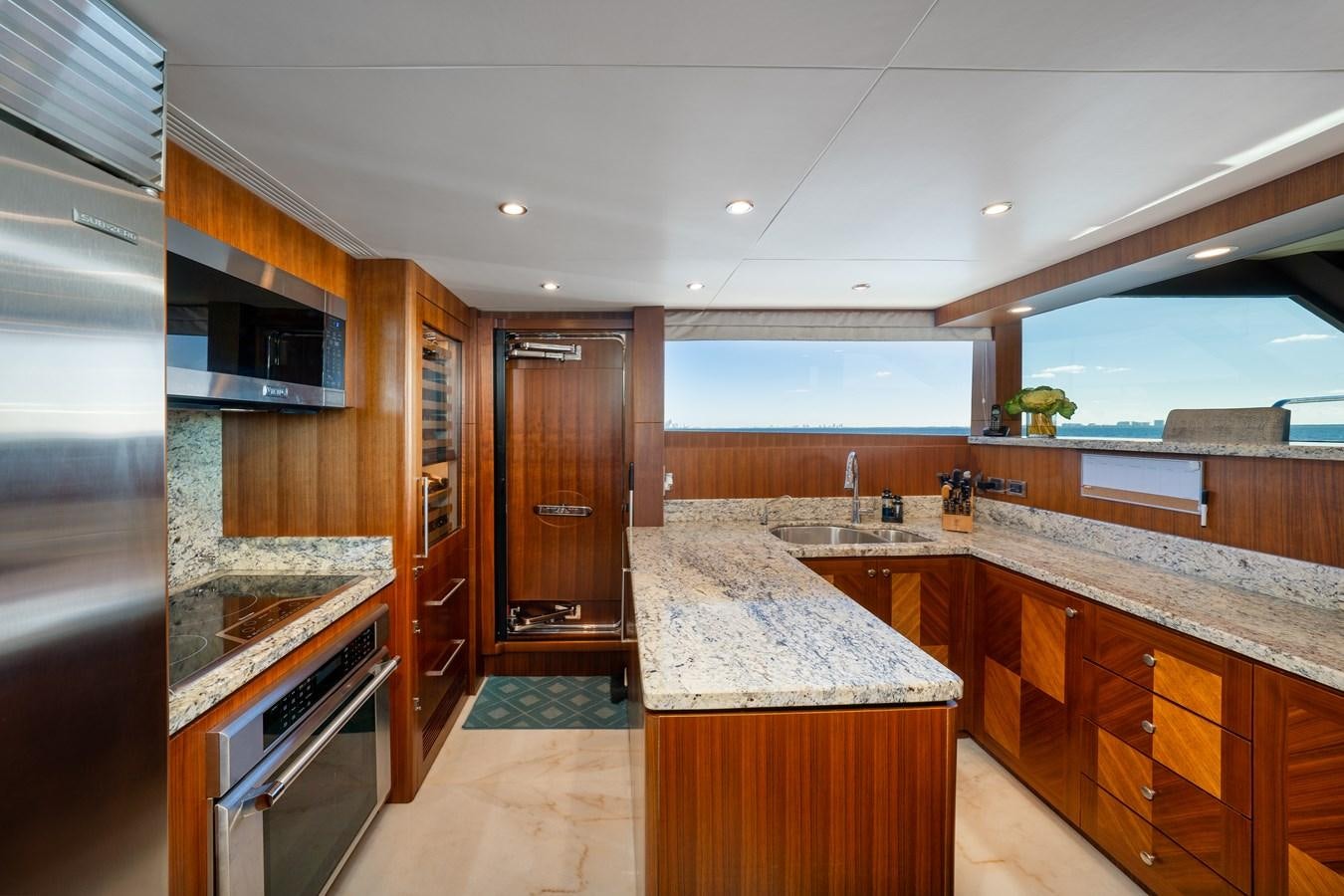 a kitchen with wooden cabinets aboard SEA N SEA Yacht for Charter