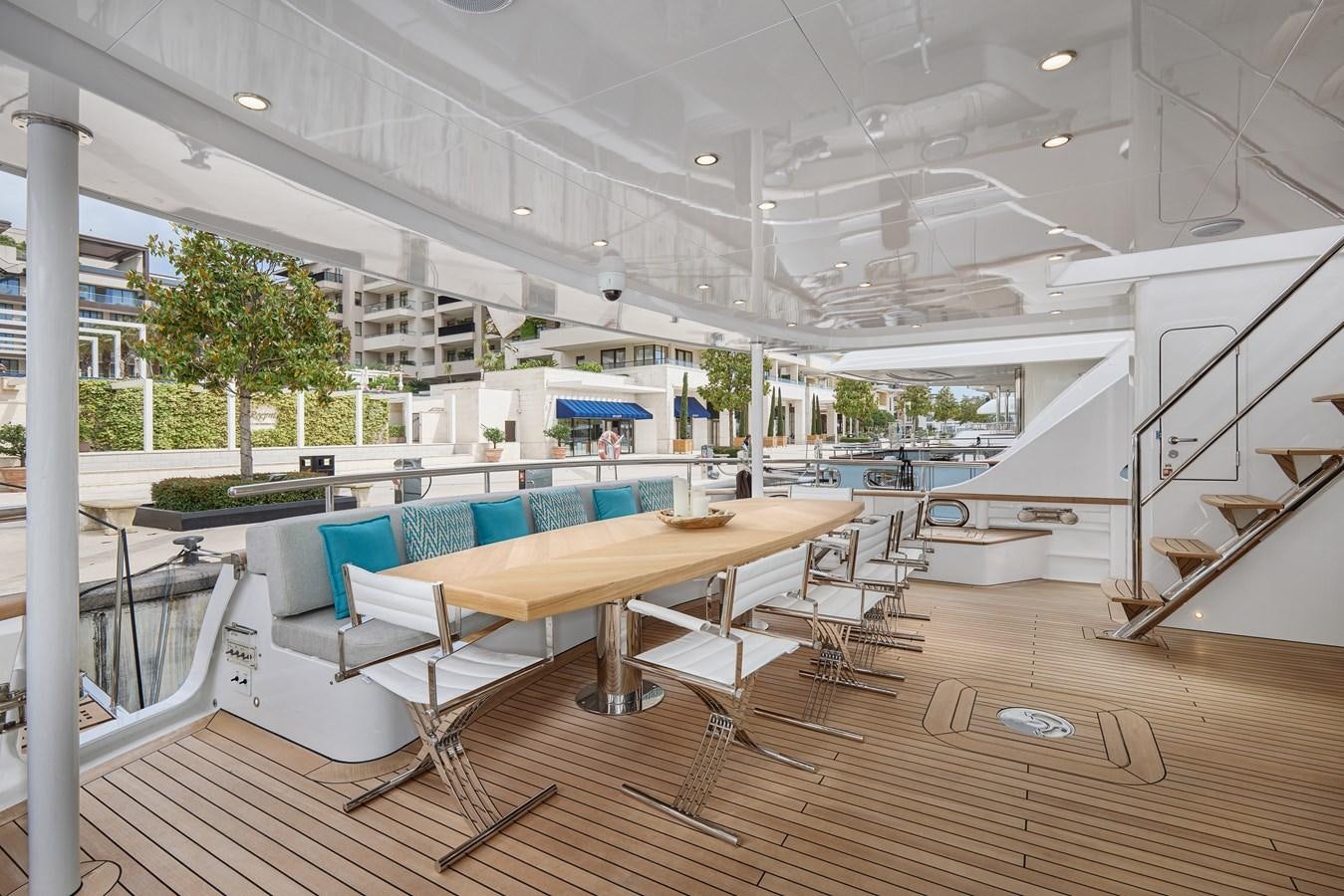 a room with tables and chairs aboard STEEL TRANSATLANTIC NAVETTA 2022 "TEMBEA" Yacht for Sale