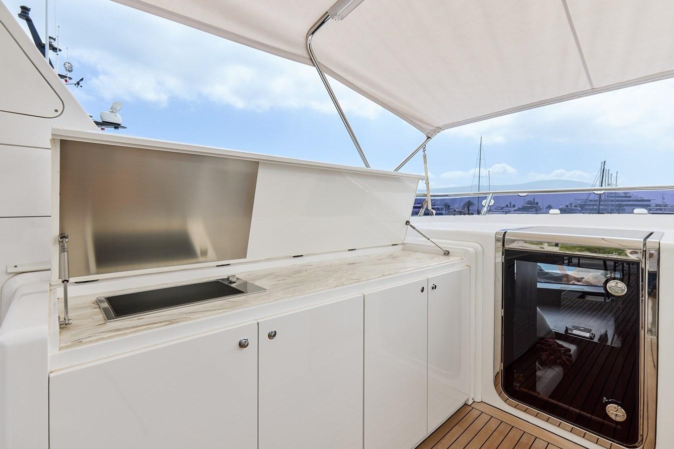 a white kitchen with a large window aboard STEEL TRANSATLANTIC NAVETTA 2022 "TEMBEA" Yacht for Sale