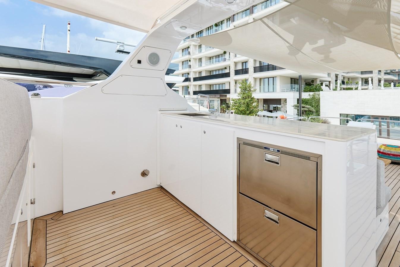 a kitchen with white cabinets aboard STEEL TRANSATLANTIC NAVETTA 2022 "TEMBEA" Yacht for Sale
