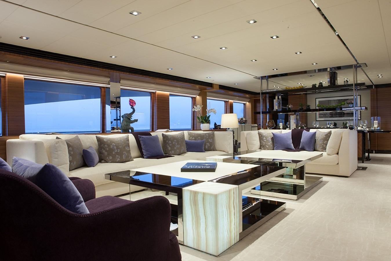 a living room with a large sofa aboard DAISY D Yacht for Sale