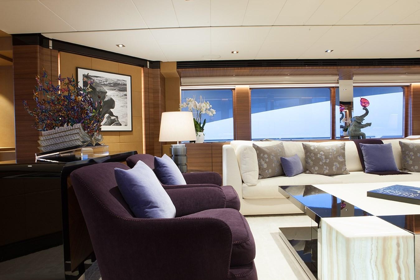 a living room with a couch and a table aboard DAISY D Yacht for Sale