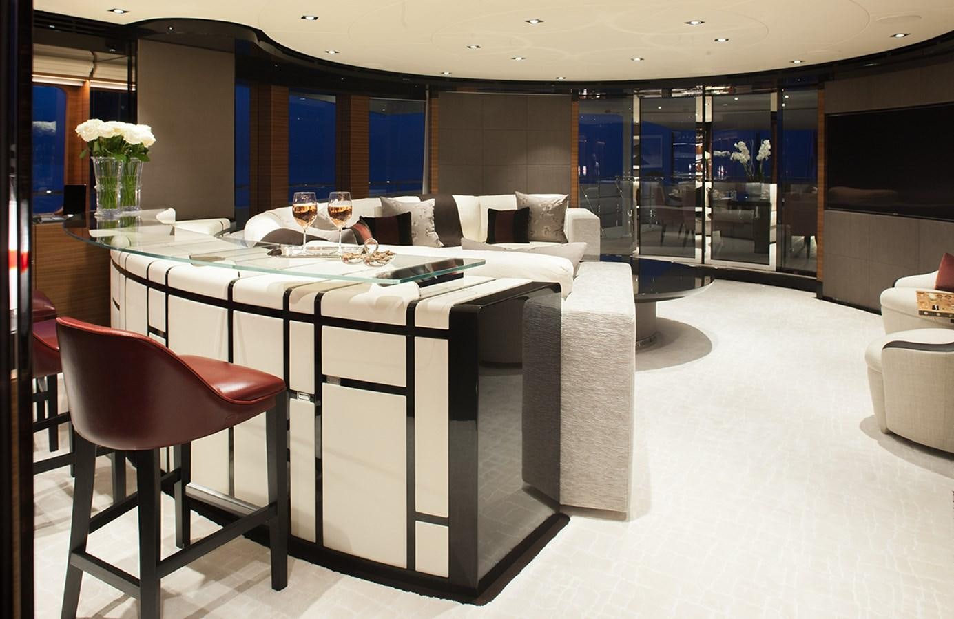 a room with a table and chairs aboard DAISY D Yacht for Sale