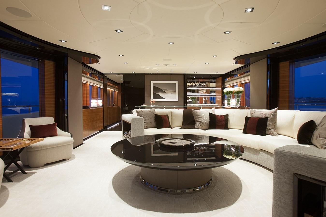 a living room with a large white sofa and a coffee table aboard DAISY D Yacht for Sale