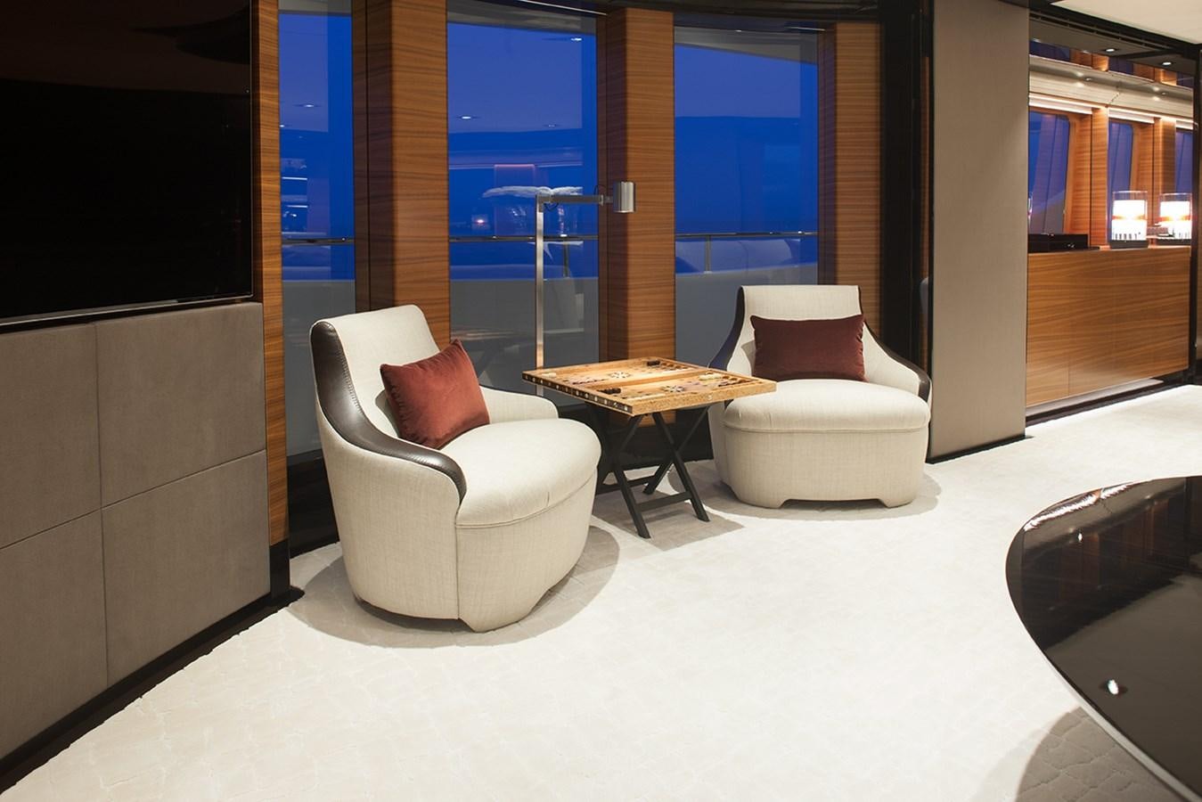 a room with a table and chairs aboard DAISY D Yacht for Sale