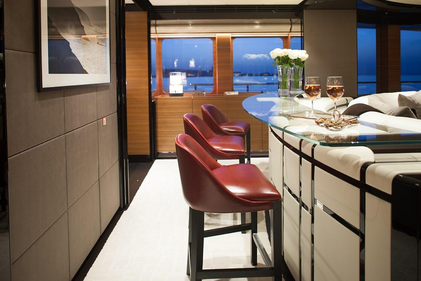 a table with wine glasses on it aboard DAISY D Yacht for Sale