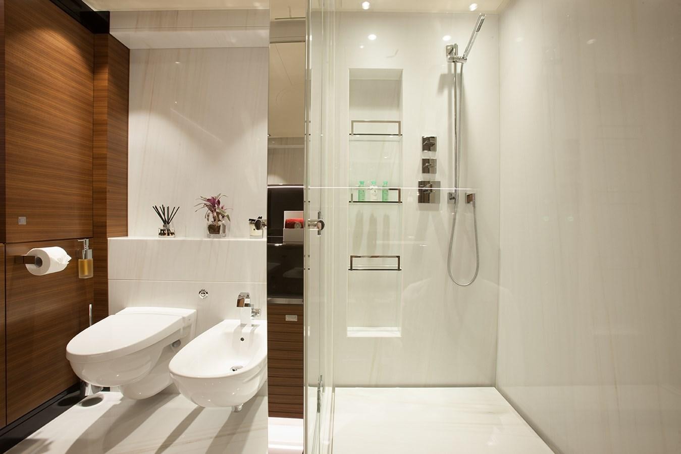 a bathroom with a glass shower aboard DAISY D Yacht for Sale