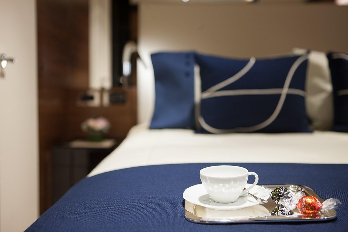 a cup of tea on a bed aboard DAISY D Yacht for Sale