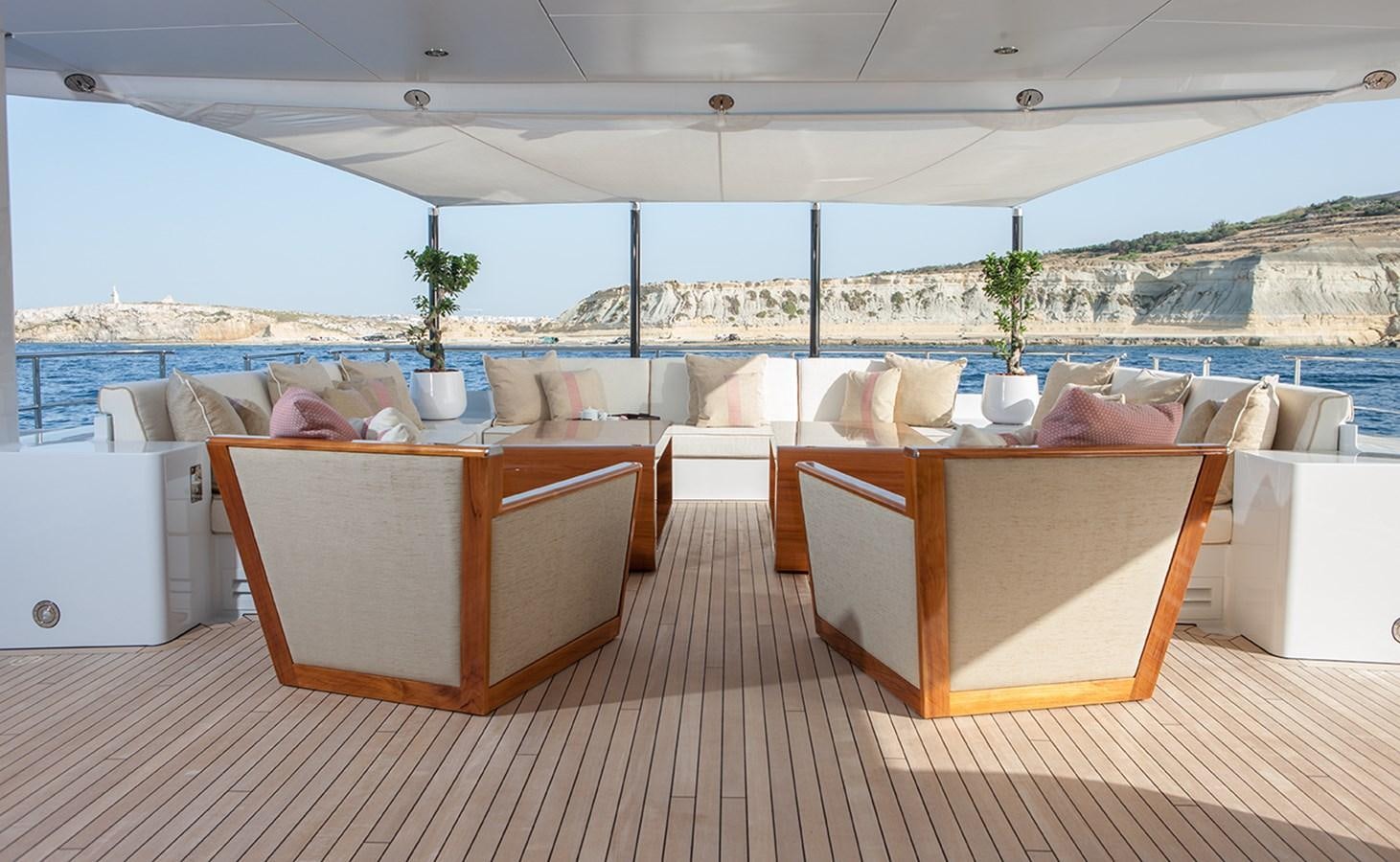 a room with a table and chairs aboard DAISY D Yacht for Sale