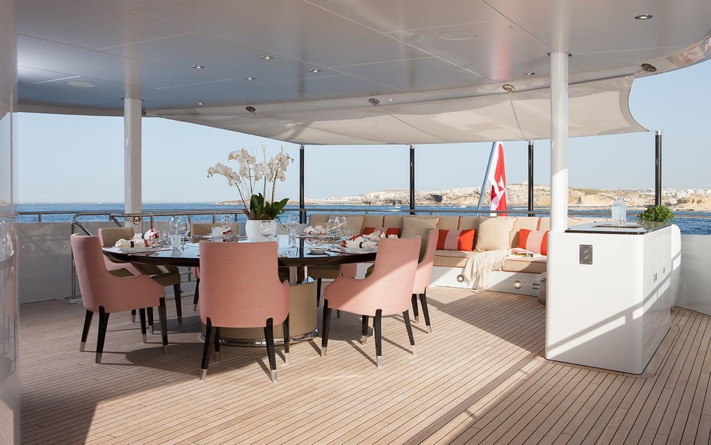 a room with tables and chairs aboard DAISY D Yacht for Sale