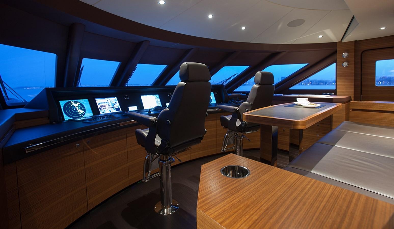 a room with a desk and chairs aboard DAISY D Yacht for Sale