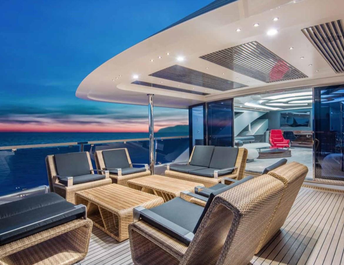 a lounge area with a couch and a large pool aboard EUPHORIA II Yacht for Sale