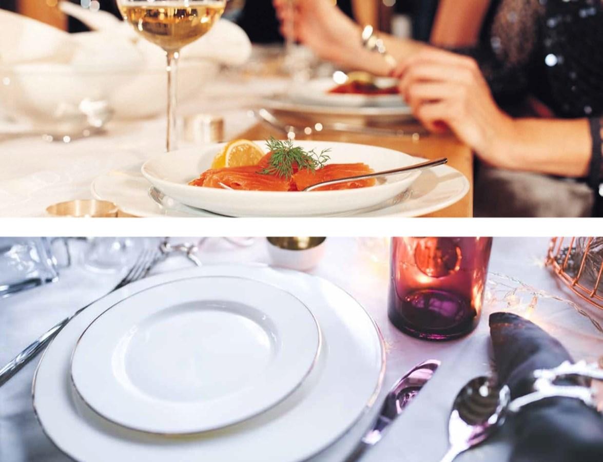 a table with plates of food and glasses of wine aboard EUPHORIA II Yacht for Sale