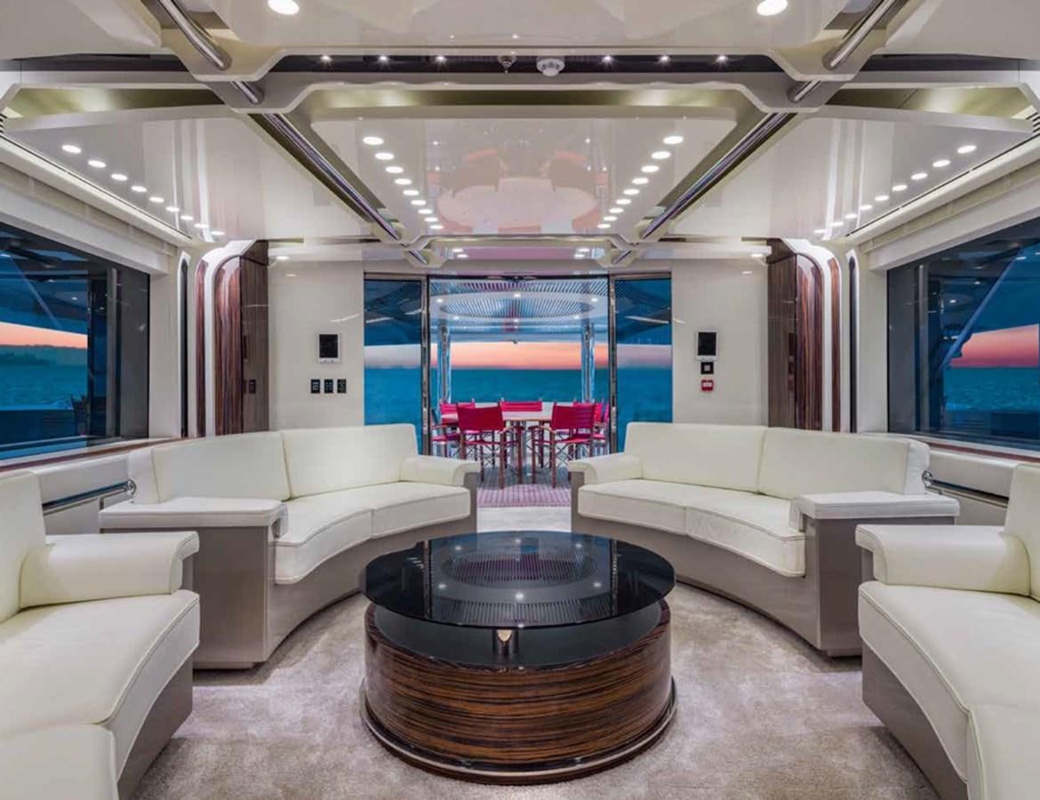 a living room with a table and couches aboard EUPHORIA II Yacht for Sale