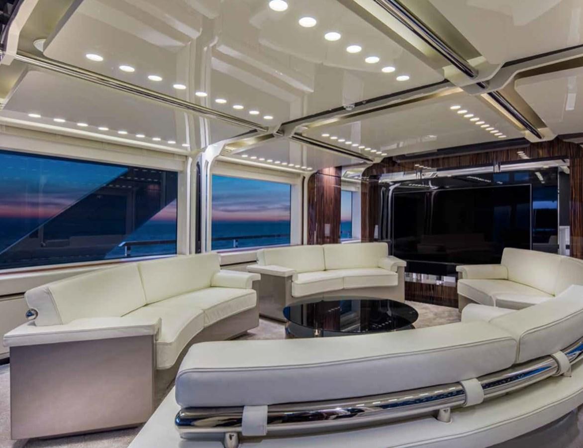 a room with a couch and a television aboard EUPHORIA II Yacht for Sale