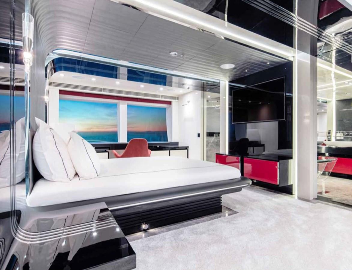 a room with a bed and a couch aboard EUPHORIA II Yacht for Sale