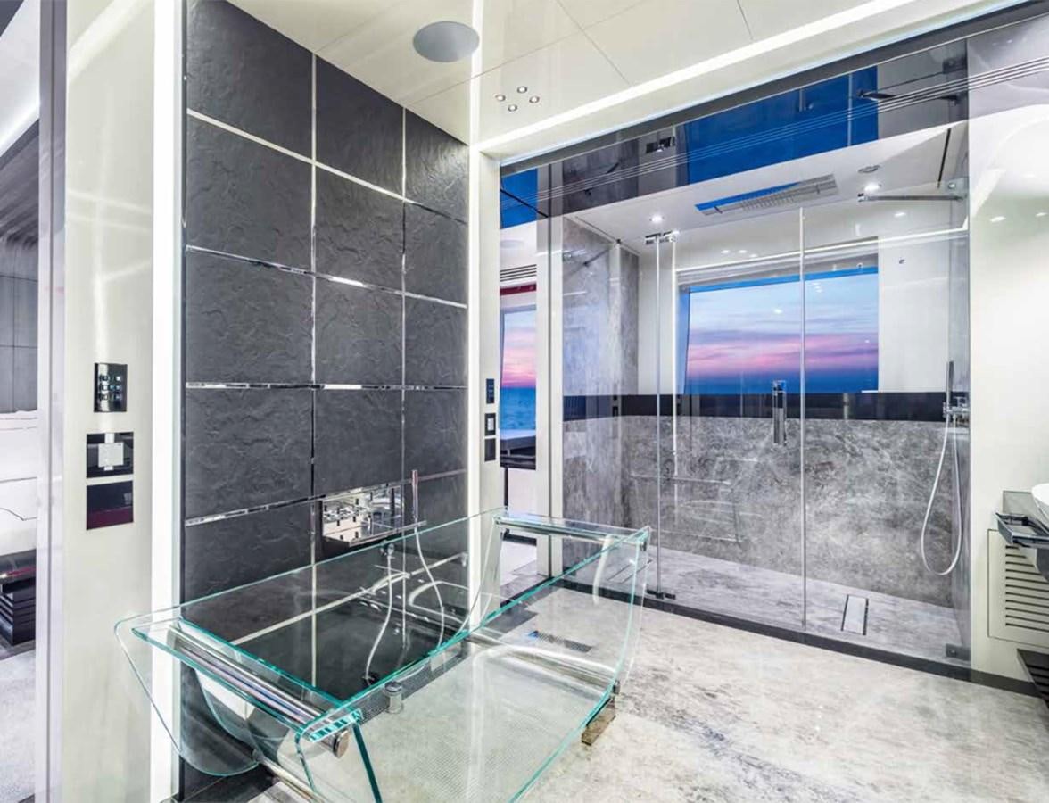 a large bathroom with glass walls aboard EUPHORIA II Yacht for Sale