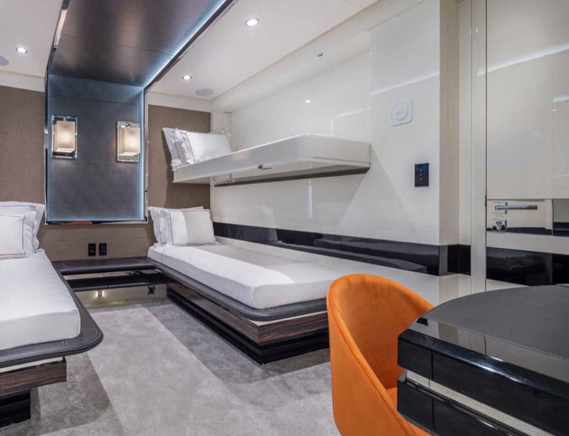 a room with a bed and a desk aboard EUPHORIA II Yacht for Sale