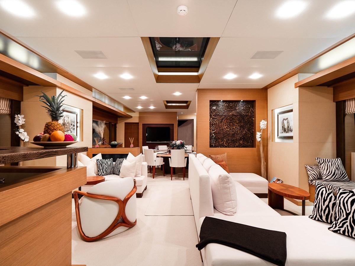 a room with a couch and a table and chairs aboard NAMASTE 8 Yacht for Sale