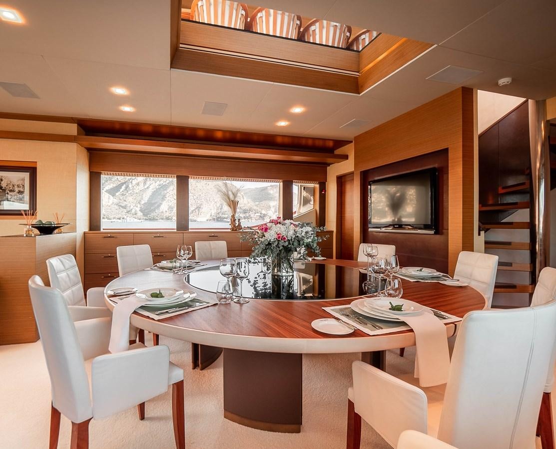 a dining room with a table and chairs aboard NAMASTE 8 Yacht for Sale