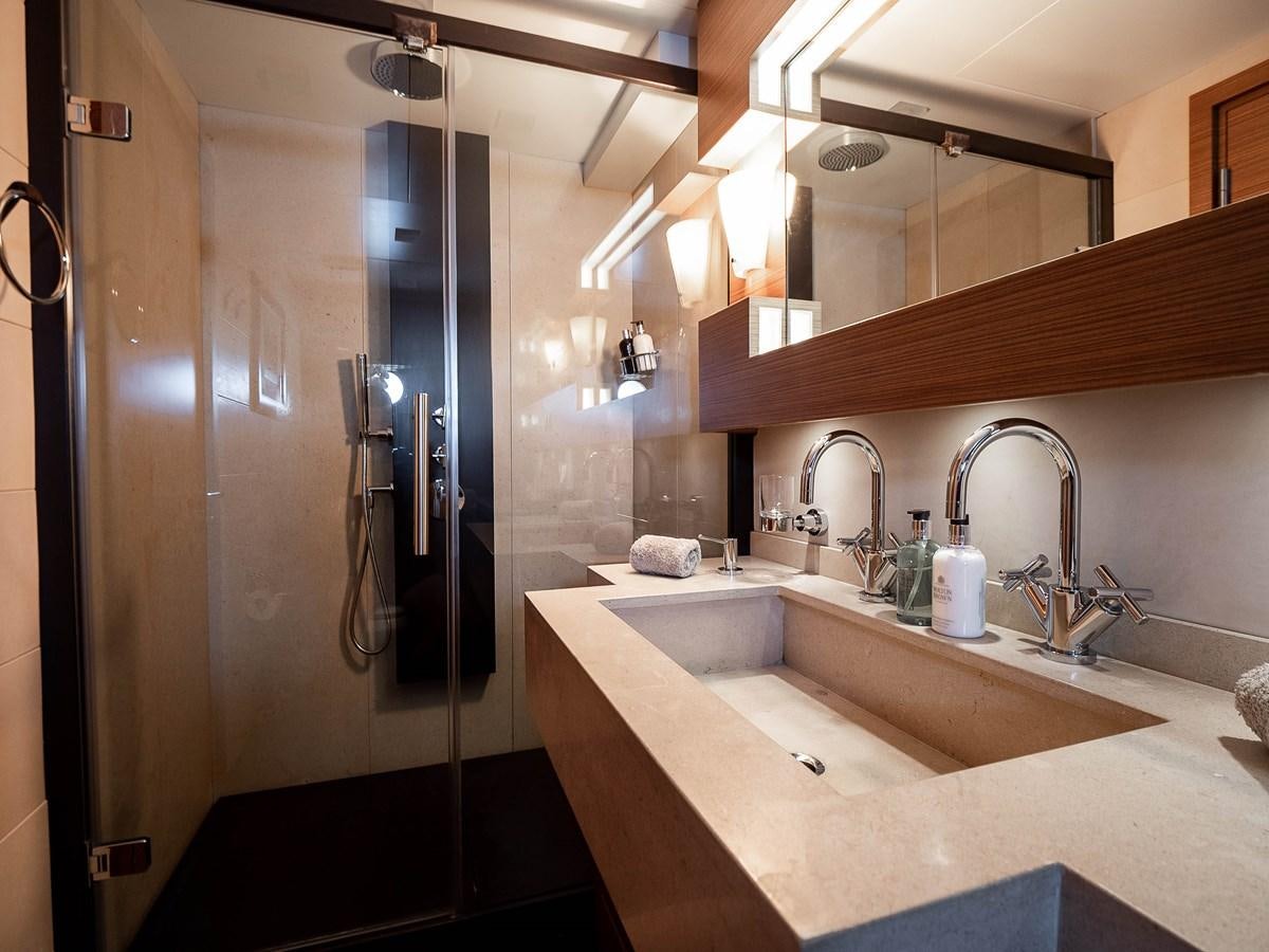 a bathroom with a sink and a shower aboard NAMASTE 8 Yacht for Sale
