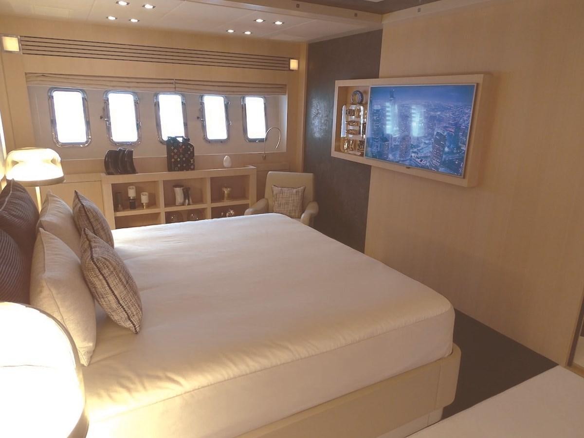 a bed with a large screen aboard TOTAL Yacht for Charter