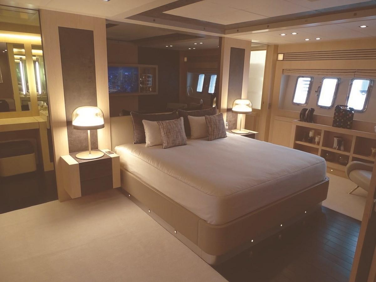 a large bedroom with a large bed aboard TOTAL Yacht for Charter