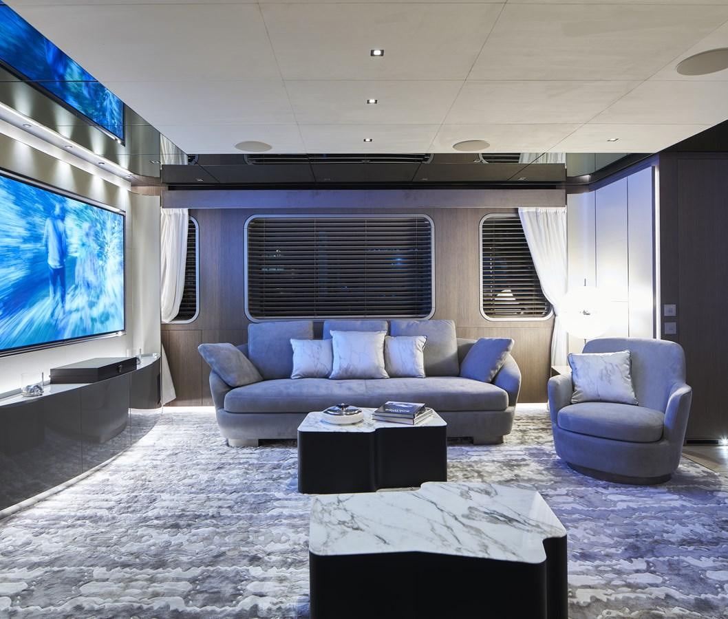 a living room with a large screen aboard SP1 Yacht for Sale