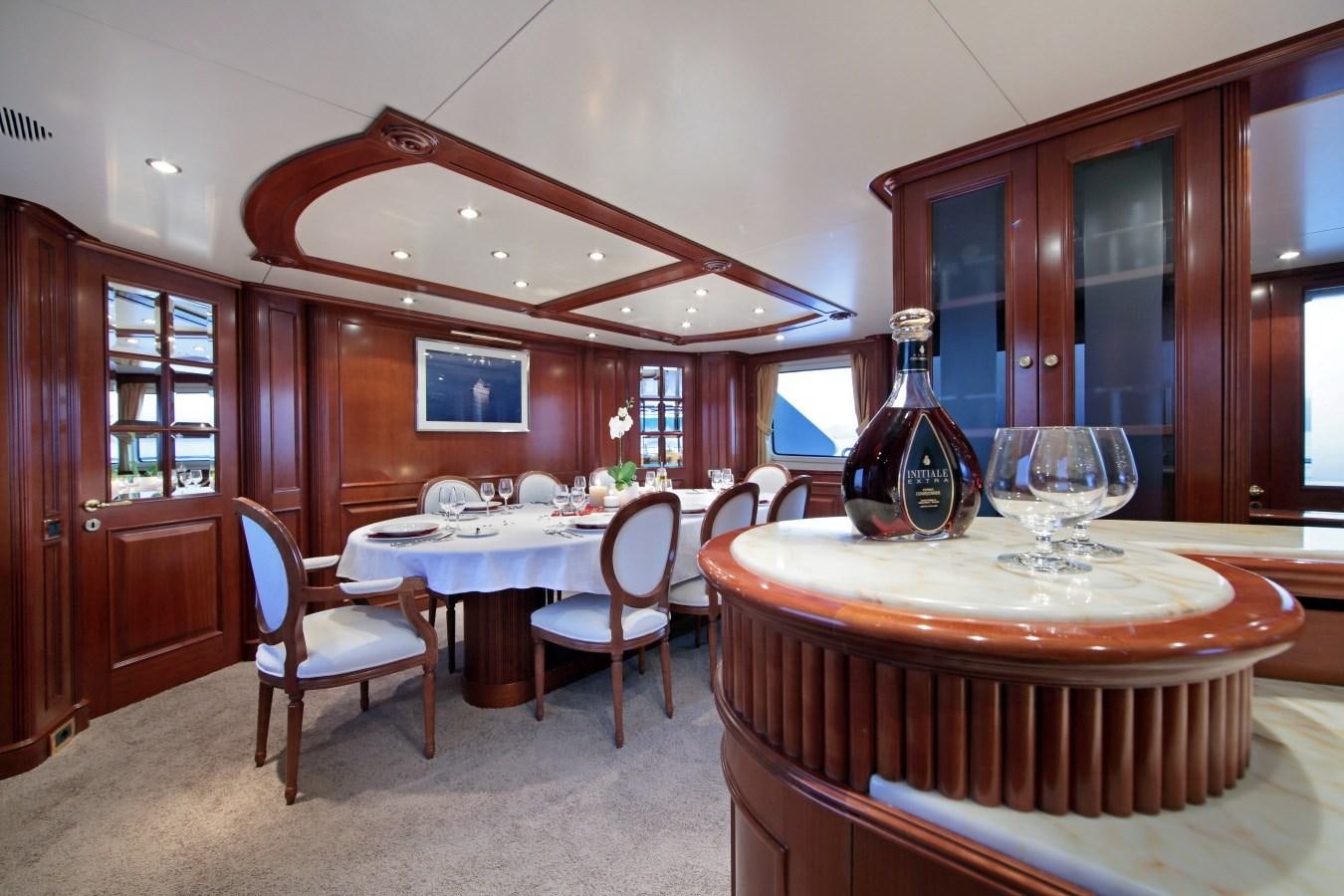 a dining room with a table and chairs aboard INOUIS Yacht for Sale