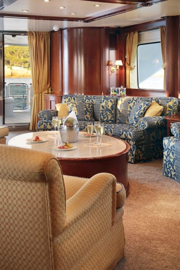 a living room with a couch and a table aboard INOUIS Yacht for Charter