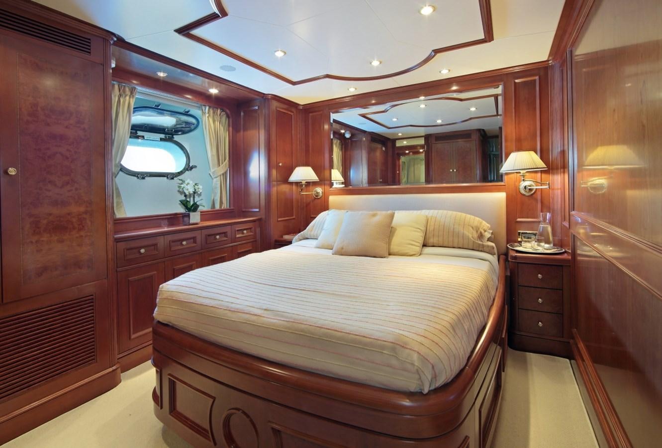 a bedroom with a bed and a mirror aboard INOUIS Yacht for Charter