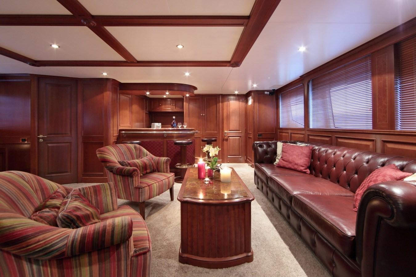 a living room with a couch and a coffee table aboard INOUIS Yacht for Charter