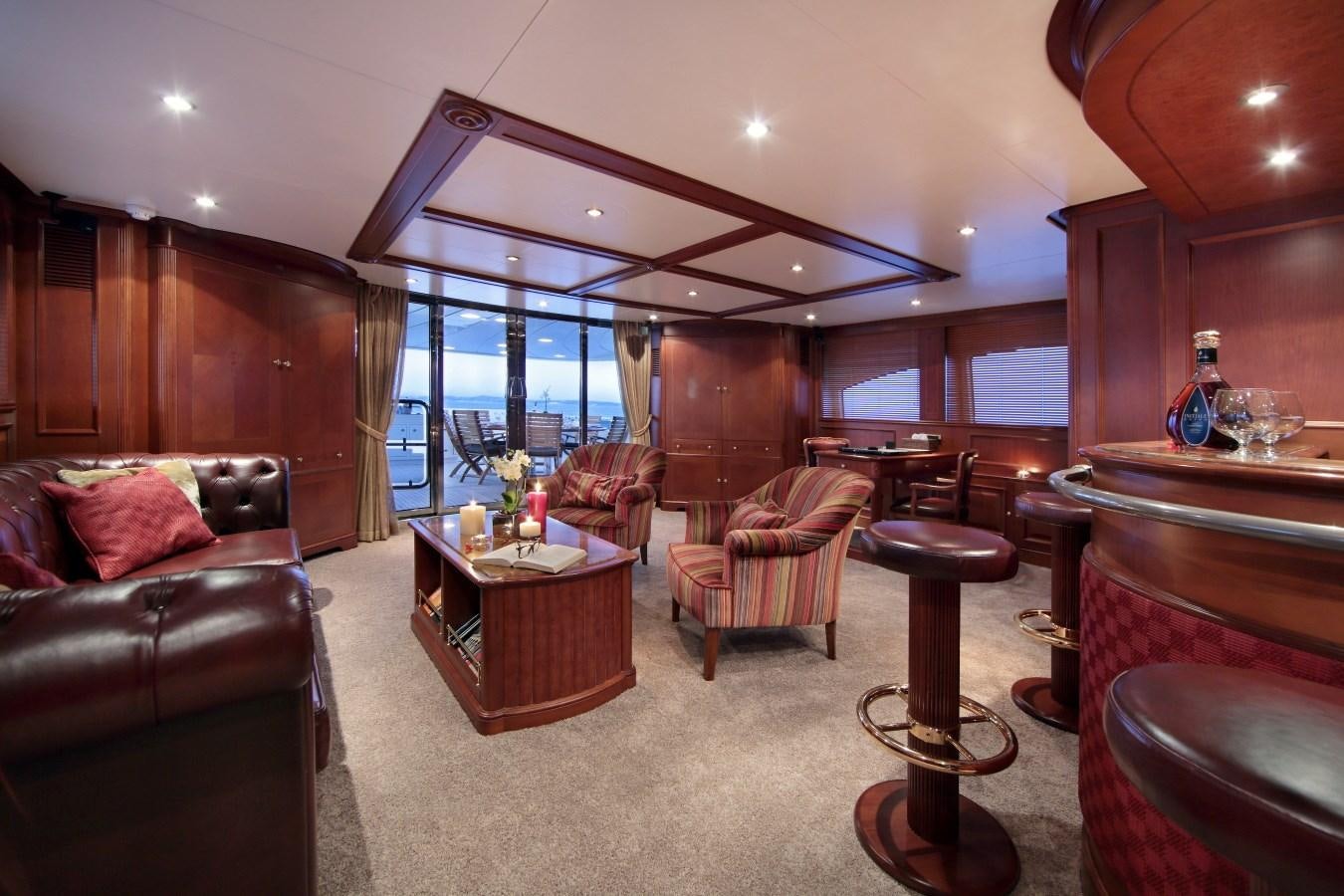 a living room with a wood paneled wall aboard INOUIS Yacht for Charter