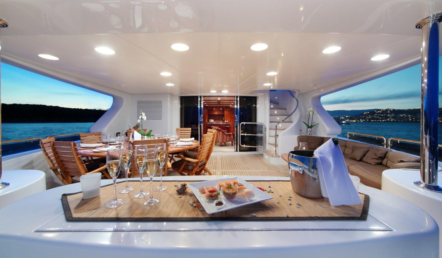 a large room with a table and chairs aboard INOUIS Yacht for Charter
