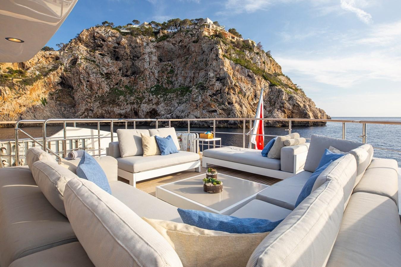 a large living room with a large rock formation behind it aboard ORSO 3 Yacht for Sale