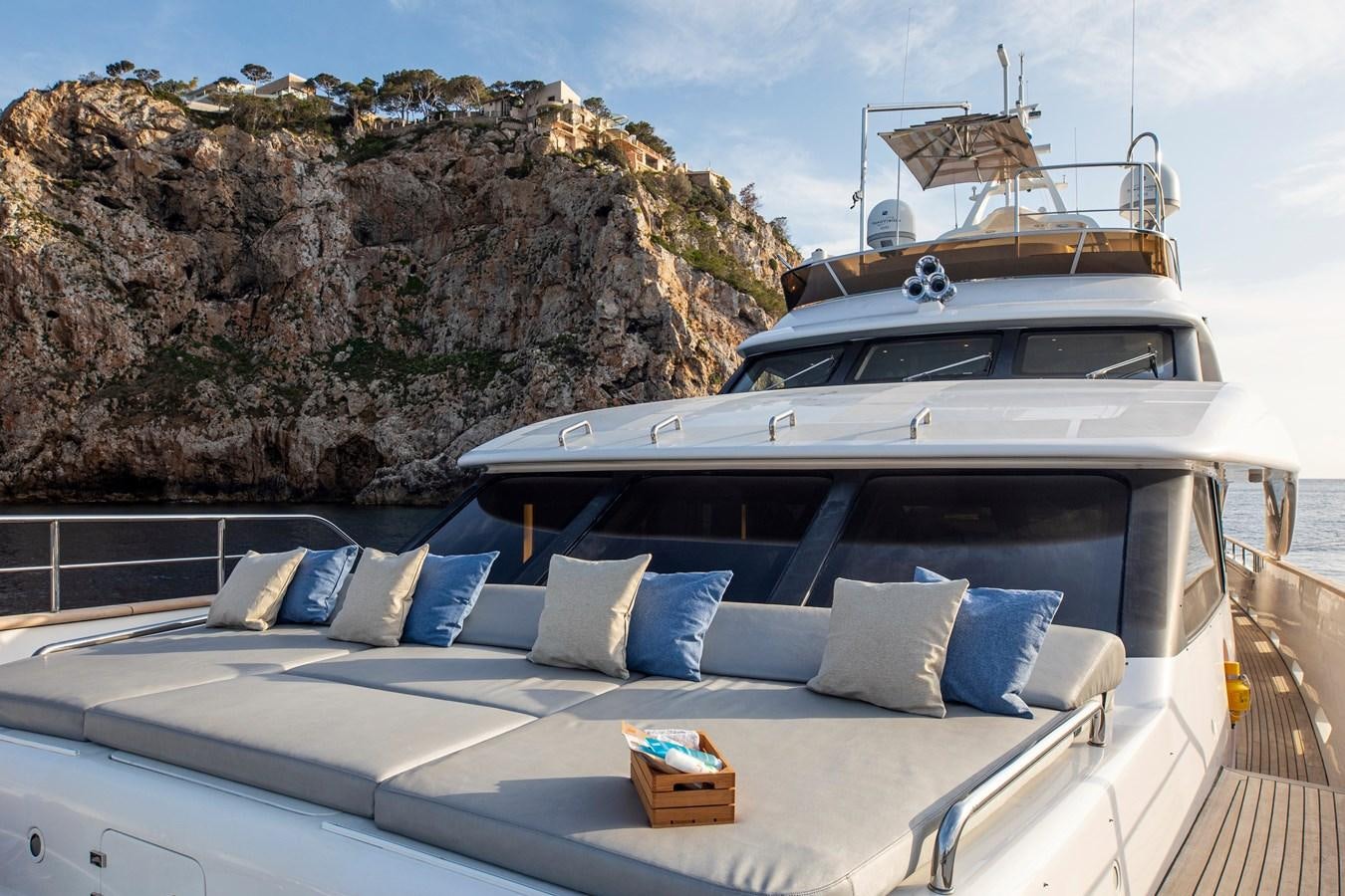 a bed with a white bed spread aboard ORSO 3 Yacht for Sale