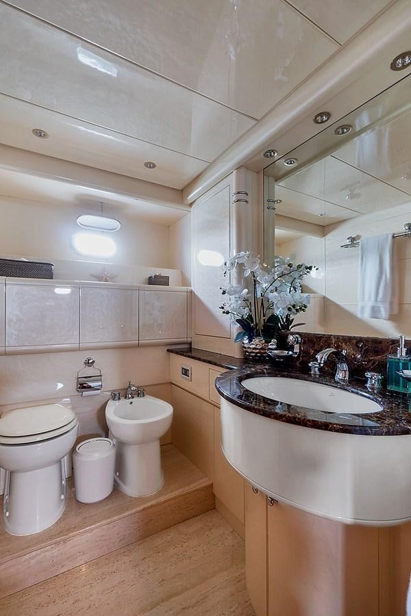 a bathroom with a sink toilet and a mirror aboard HAKUNA MATATA Yacht for Sale