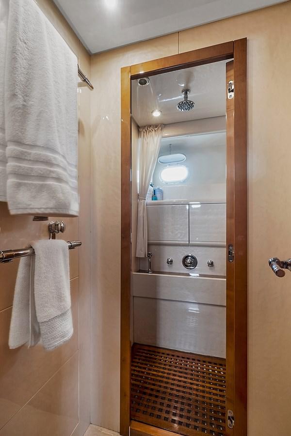 a bathroom with a glass shower aboard HAKUNA MATATA Yacht for Sale