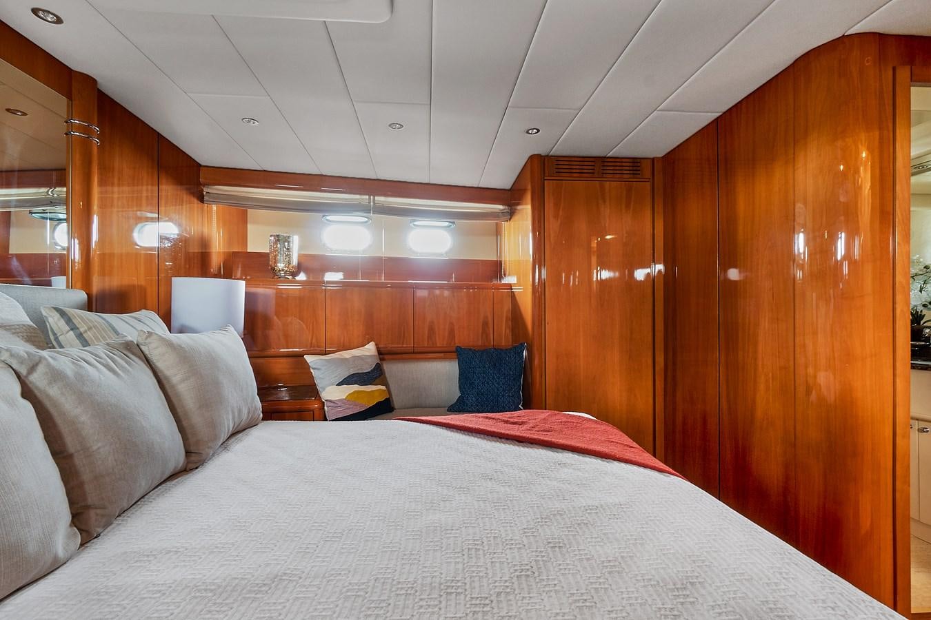a bed with a white sheet and pillows aboard HAKUNA MATATA Yacht for Sale
