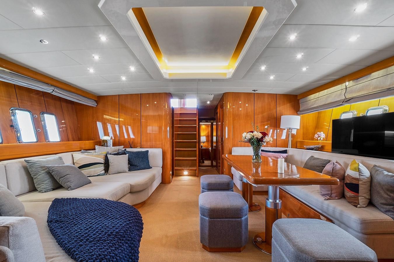 a living room with a large wood floor aboard HAKUNA MATATA Yacht for Sale