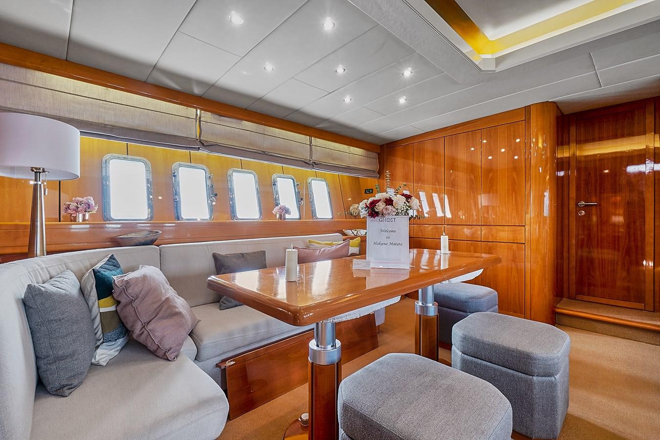 a living room with a couch and a coffee table aboard HAKUNA MATATA Yacht for Sale