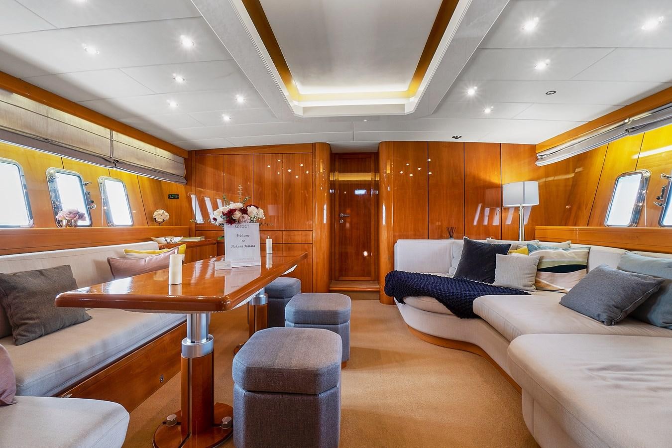 a living room with a couch and a table aboard HAKUNA MATATA Yacht for Sale